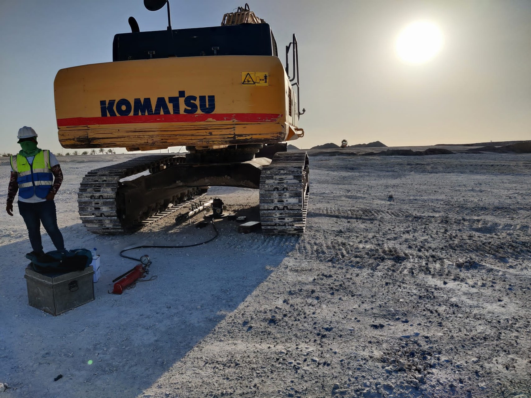 In-situ plate load test beside a Komatsu excavator